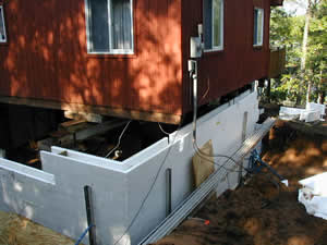 Underpinning an existing home with our insulated poured foundation wall system 